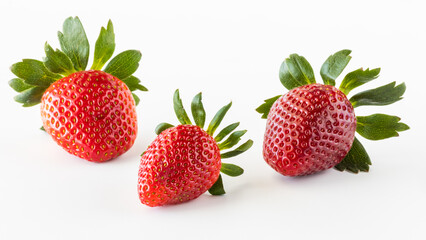 Three juicy ripe strawberries isolated against a white background.