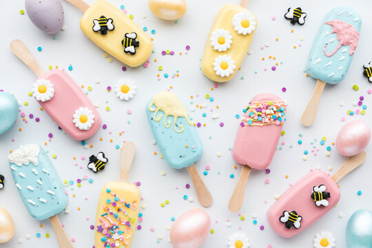 Top down view of several homemade cakesicles decorated for Spring.