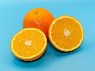 Closeup of a cut orange on a blue background