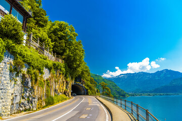 Lake Thun, road and tunnel near mountains, Thunersee Bern Switzerland