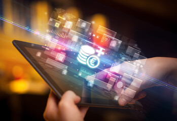 Close-up of a hand using tablet, currency concept