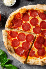 Pepperoni Pizza with Mozzarella Cheese, Salami, Tomato Sauce on Dark Background, Freshly Baked Pizza