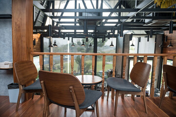 Seats and table on second floor with outdoor view at coffee shop
