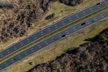 Aerial top view of cars on the highway running through a salt marsh in Long Island