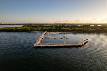 Fototapeta na wymiar Aerial view of a pier surrounded by waters in North Palm Beach, Florida