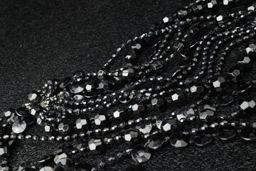 Beautiful black bead necklaces on a black background
