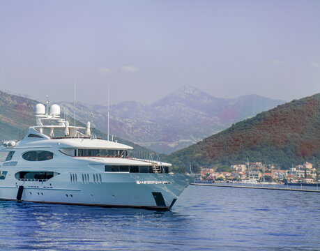 stock photo of luxury private motor yacht in tropical sea with bow wave