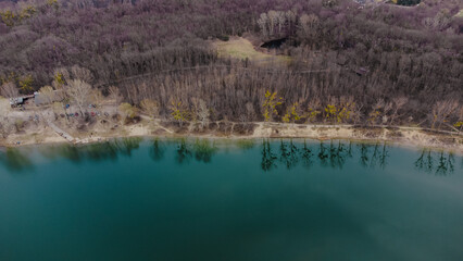 A wonderful lake in the middle of the forest near the city. A place of rest near the city.