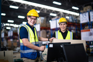 Asian warehouse workers team Checks Stock and Inventory on Desktop Computer in retail warehouse full of shelves with goods. teamwork at warehouse storage department.