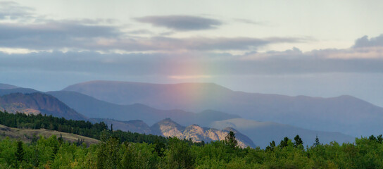 Canadian Mountain Landscape. Dramatic Sunset with Rainbow. Yukon, Canada.