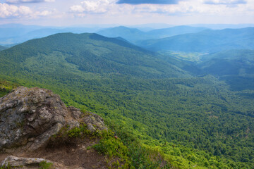countryside summer landscape. grassy hills and steep slopes. wonderful adventures in carpathian mountains