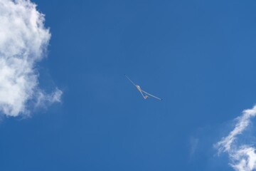 Scenic view of a glider over the mountains against the blue sky