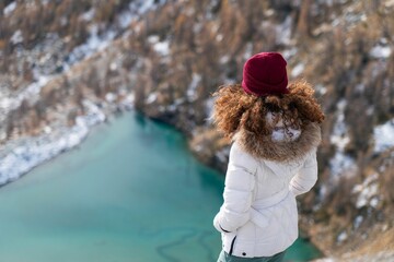 Overhead shot of a female looking at the Lago Blue lake in Ayas Valley, Monte Rosa mountain, Italy