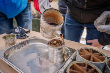 Trench candles on the table poured with wax, made by Ukrainian volunteers for soldiers serving on the front line.