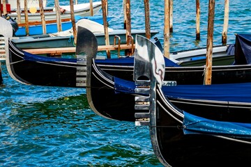 Closeup shot of gondolas moored onto the pier in Venice, Italy