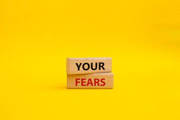 Your fears symbol. Wooden blocks with words Your fears. Beautiful yellow background. Business and Your fears concept. Copy space.
