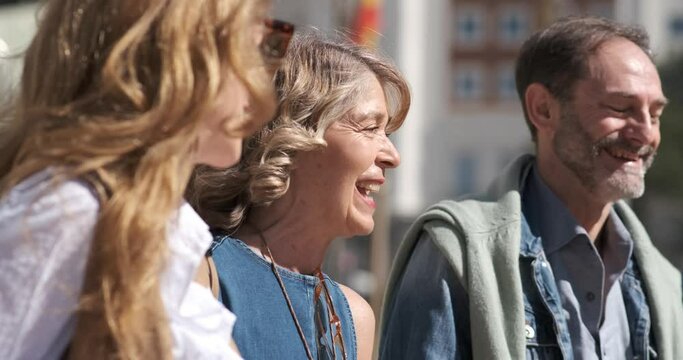 Smiling mature friends walking on street