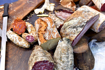 Various home made bread and game meat specialties prepared and smoked, presented at a hunting fair.