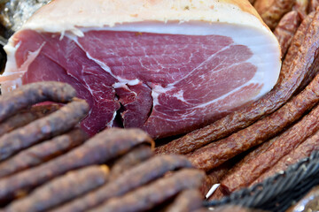 Various home made game meat specialties prepared and smoked, presented at a hunting fair. Selective focus.
