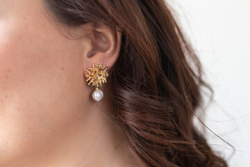 Glamour and beauty, jewelry and luxury concept - close up of beautiful woman face with pearl earring