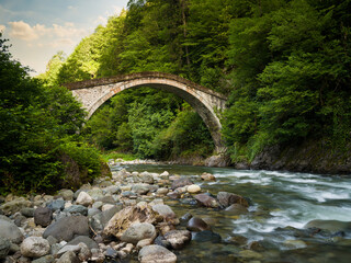 Historical Mikron Bridge in Camlihemsin at sunrise. Turkey's historical stone bridges. Rize, Turkey
