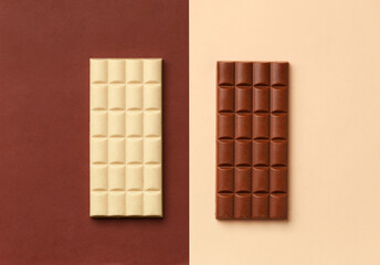 Two chocolate bars on a brown and beige background.