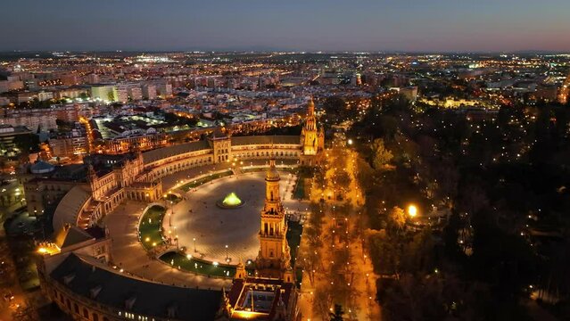 4k Aerial view of Plaza de Espana at sunrise in Seville, Spain. Night view of Maria Luisa Park