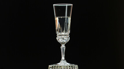 On a holiday, champagne is poured into a crystal glass.