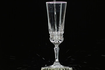 On a holiday, champagne is poured into a crystal glass.
