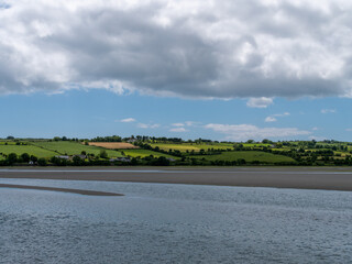 White cumulus clouds in the sky over the hilly Irish countryside. Green hills on a nice summer day....