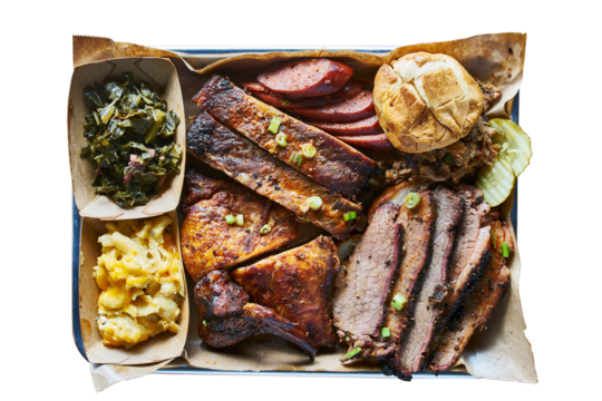 texas bbq style tray with smoked beef brisket, st louis ribs, chicken and hot links isolated and shot from top view