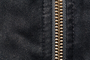 Plastic zipper background. Dark black coat zipper. Empty copy space fabric texture. Closeup zipper teeth. Metal shiny clothing part. Closeup zipped zipper.
