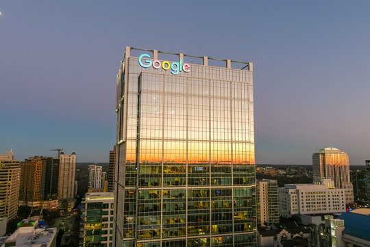 overhead aerial shot of the office buildings and skyscrapers with cars driving on the street and roads lined with trees in Atlanta Georgia USA