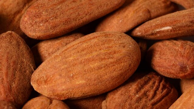 Almonds turning slowly in close up