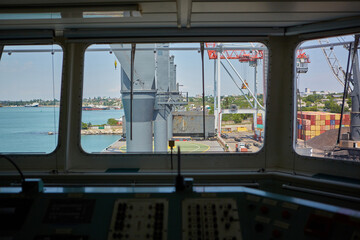 View from bulk carrier's captain's bridge to bulk cargo berth. View of port terminal from inside of...