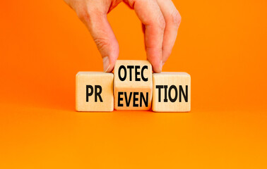 Protection and prevention symbol. Concept word Protection Prevention on wooden cubes. Businessman hand. Beautiful orange table orange background. Business protection prevention concept. Copy space.