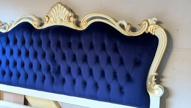 navy color upholstery bed and carved motif