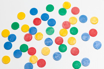 colorful round plastic tokens isolated on white background