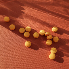 Yellow pills in a transparent glass. Close up. Place for text. Medicine, health, beauty. High quality photo