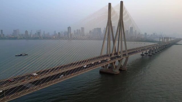 Aerial view of traffic on the Bandra Worli Sea Link cable stayed bridge with the Mumbai skyline in the background in Mumbai, Maharashtra, India.