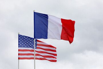 flags one from the United States of America with stars and stripes and one of tricolor France
