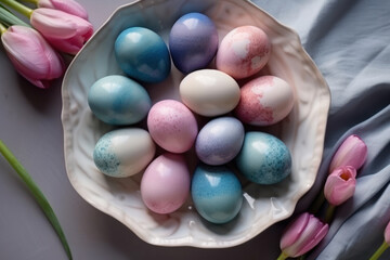 Fototapeta na wymiar Painted blue and pink Easter eggs on a porcelain dish, linen towel and pink tulips. Exquisite Easter decor. Photorealistic illustration generative AI.