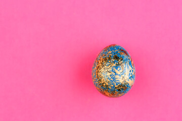 Easter egg painted blue with gold.