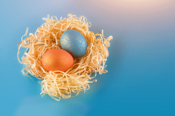 Easter eggs are painted blue with gold and orange gold.