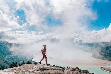 Hiking adventure in amazing nature landscape on Squamish Stawamus Chief Hike. Woman hiking on...