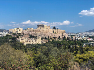 Naklejka premium The Acropolis of Athens, Greece, with the Parthenon Temple on top of the hill during a summer sunset