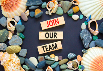 Join our team symbol. Concept words Join our team on wooden block on a beautiful black table black...