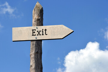 Exit - wooden signpost with one arrow, sky with clouds