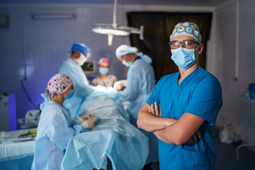 Healthcare surgical specialist. Surgeon in mask and uniform in operative room.