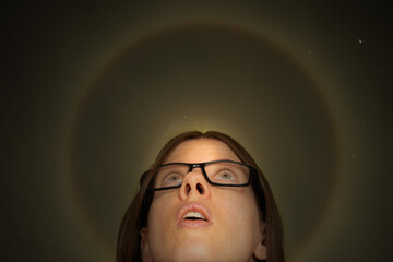 The girl looks up at the background of the heavenly halo at night over Ukraine, think